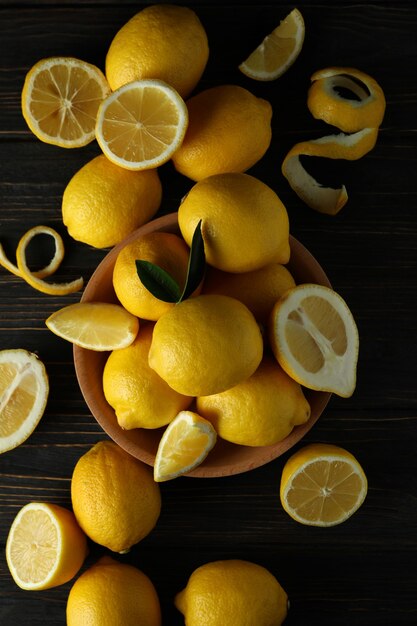 Ripe lemons on wooden, top view