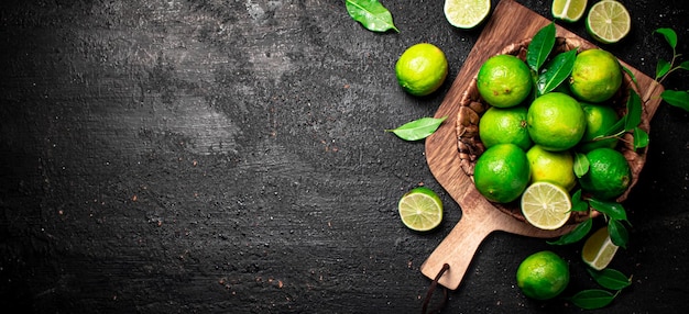 Ripe lime in a basket on a cutting board