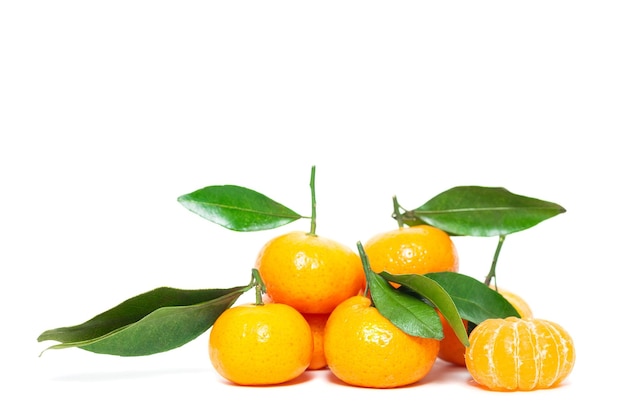 Ripe mandarines with leaves close-up on a white background. Tangerines with leaves on a white background.