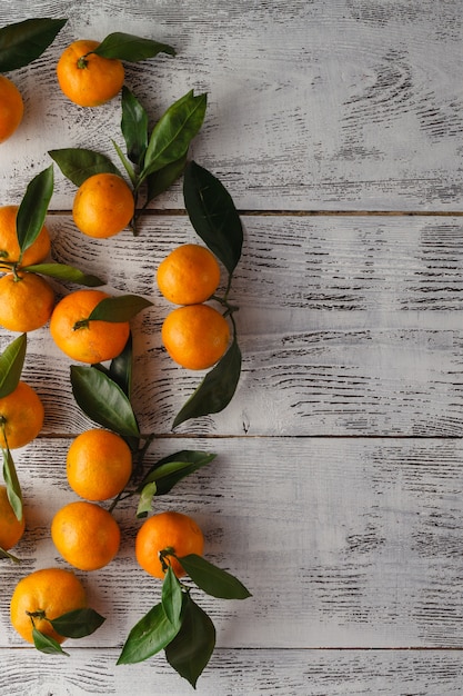 Ripe mandarins on a white wooden table