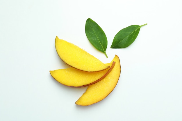 Ripe mango fruit slices on white