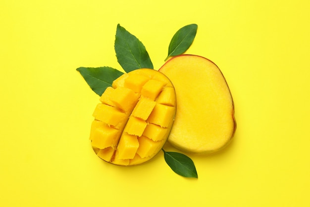 Ripe mango fruit on yellow background, close up