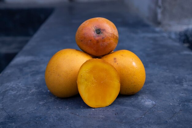 Ripe mango fruits on a dark background Closeup