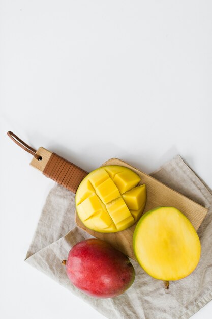 Ripe mango on the wooden cutting Board.