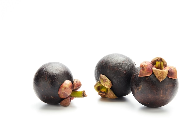 Ripe mangosteen fruit on white wall