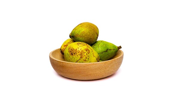 Ripe matoa fruit on a bowl with a white background