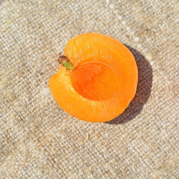 Ripe natural apricot slice on table closeup