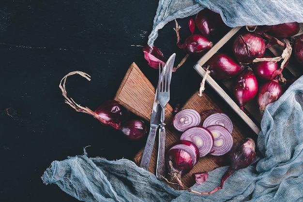 Ripe onion. On a wooden background. Top view. Free space for your text.