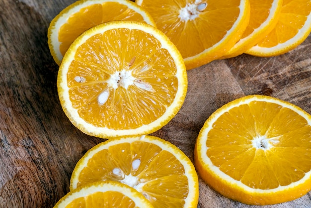 Ripe orange cut into slices during cooking