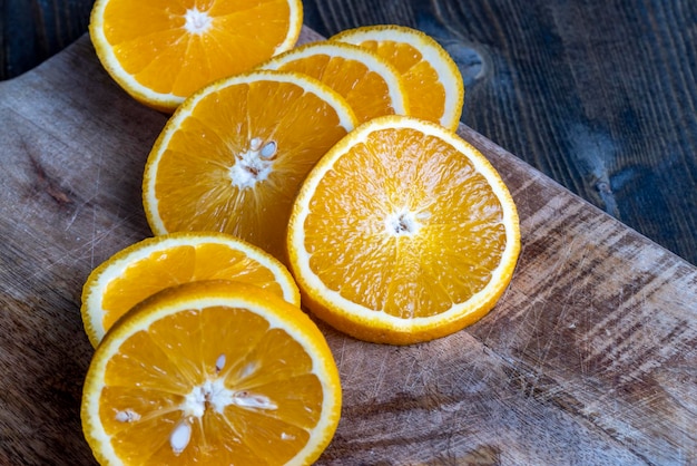 Ripe orange cut into slices during cooking