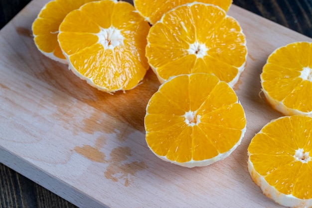 Ripe orange cut into slices during cooking