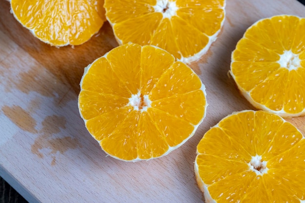 Ripe orange cut into slices during cooking