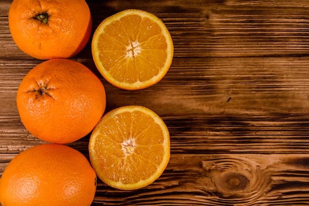 Ripe orange fruits on rustic wooden table top view