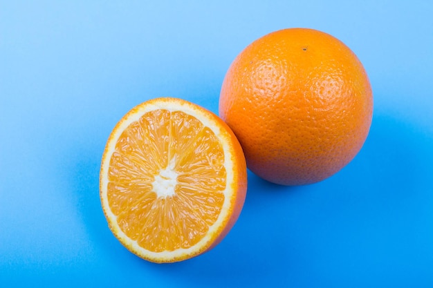 Ripe oranges on blue background