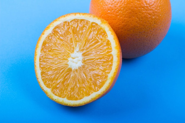 Ripe oranges on blue background