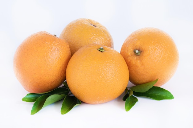 Ripe oranges isolated on the white background with green leaves. Cut Path. Copy space.