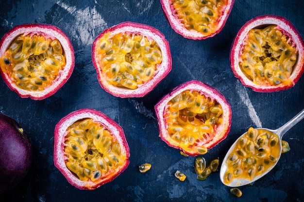 Ripe organic passion fruit on dark background above view