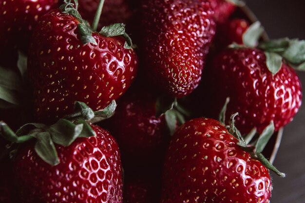 Ripe organic strawberry on a wooden background in a rustic style