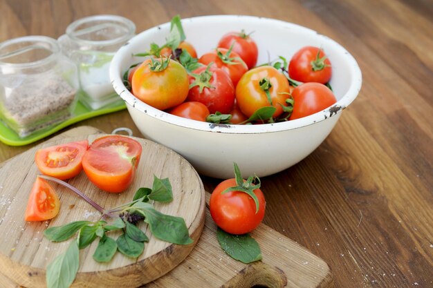 Ripe organic tomatoes in white bowl