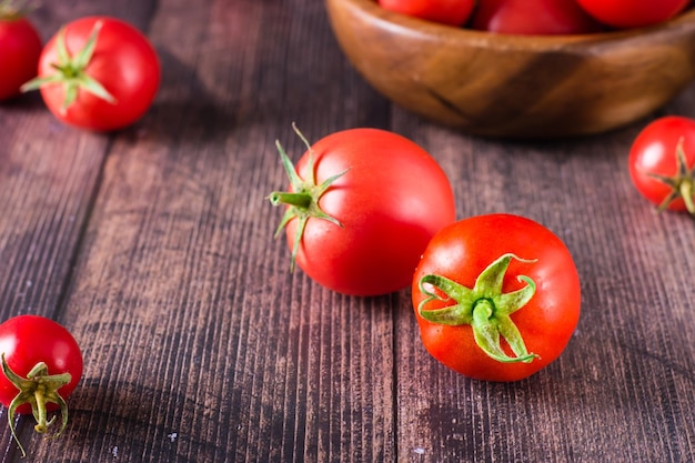 Ripe organic tomatoes on a wooden table Harvest and local products