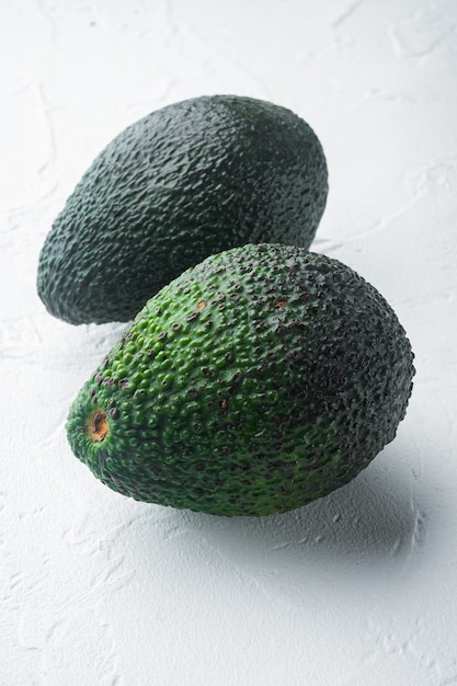 Ripe pair of green avocado set, on white table