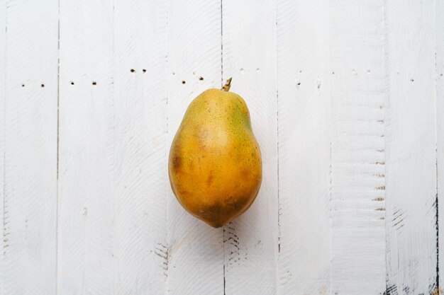 Ripe papaya on a white wooden table, Papaya cut in half