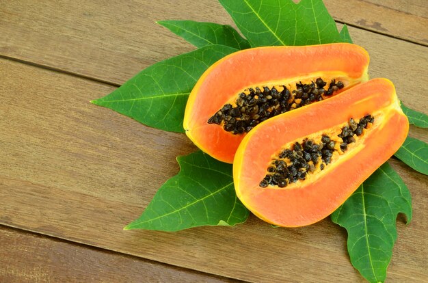 Ripe papaya on wood background