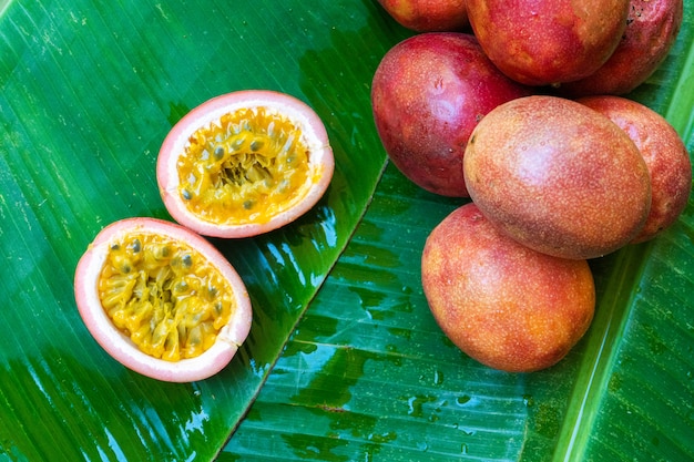 Ripe passion fruit, on a wet banana leaf. Vitamins, fruits, healthy foods