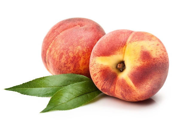 Ripe peach fruit with leaves on white background