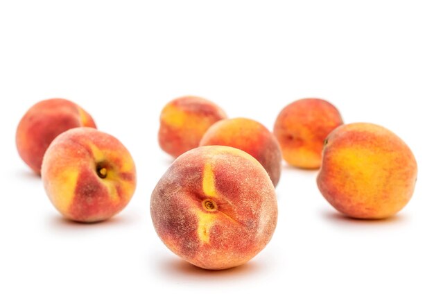 Ripe peaches on white