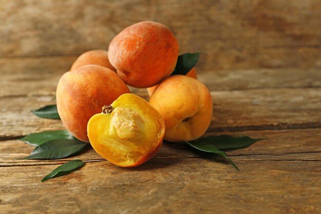 Ripe peaches on wooden background