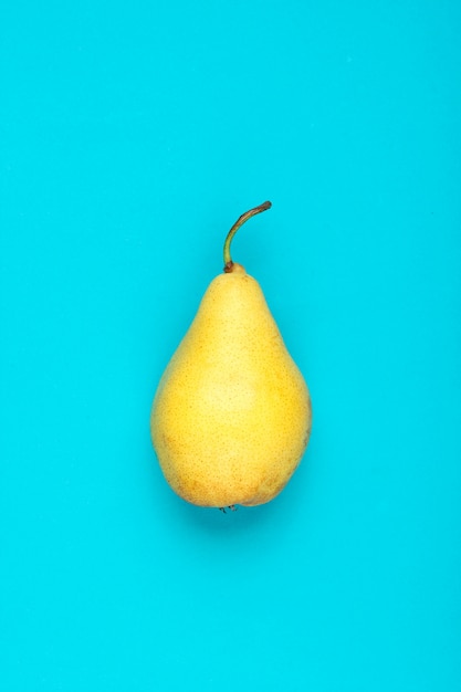 Ripe pear on blue.