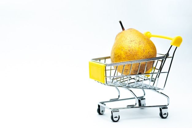 Ripe pear lies in a shopping cart isolated