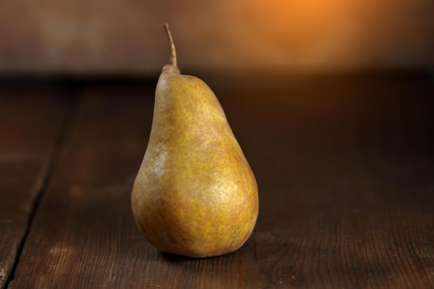 Ripe pear lying on old wooden boards