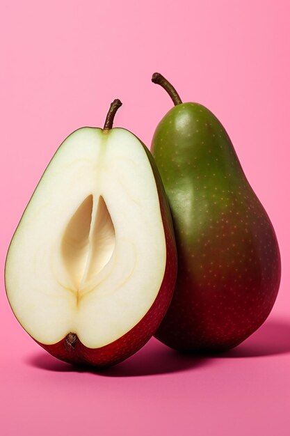 Photo ripe pears and half of pear on a pink background