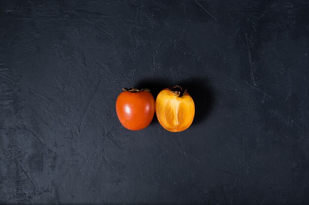 Ripe persimmon on black