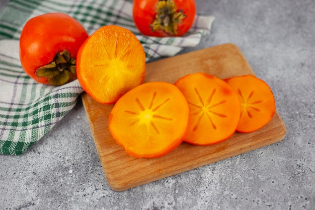 Ripe persimmon on wooden background dateplum or sharon fruit kaki persimmon fruit Local food