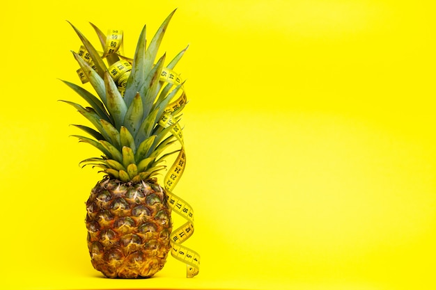 Ripe pineapple with tape measure