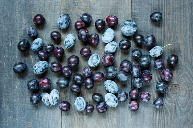 Ripe plum on the old wooden table