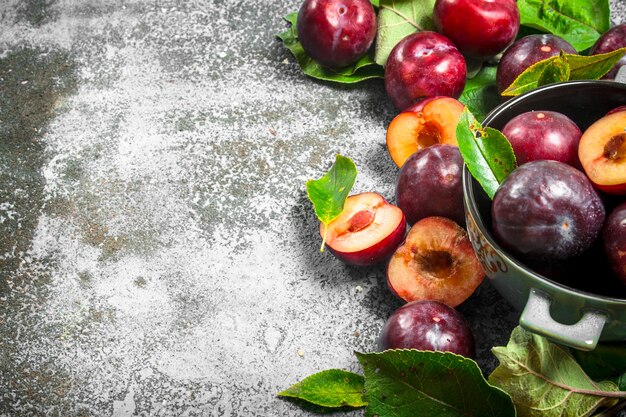 Ripe plums in a bowl.