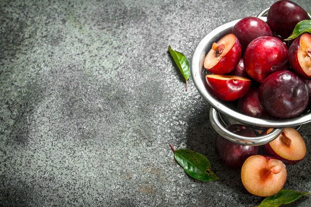 Ripe plums in a bowl.