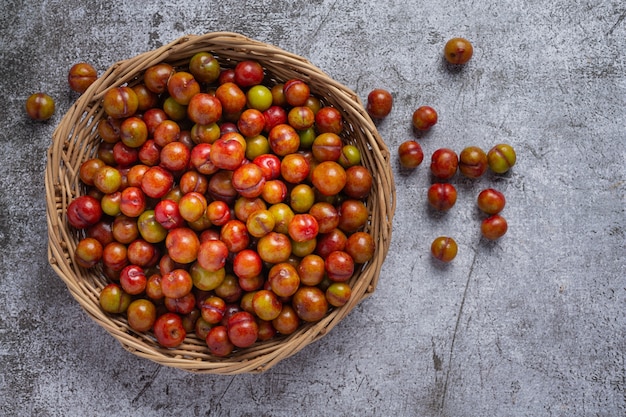 Ripe plums on the dark surface.