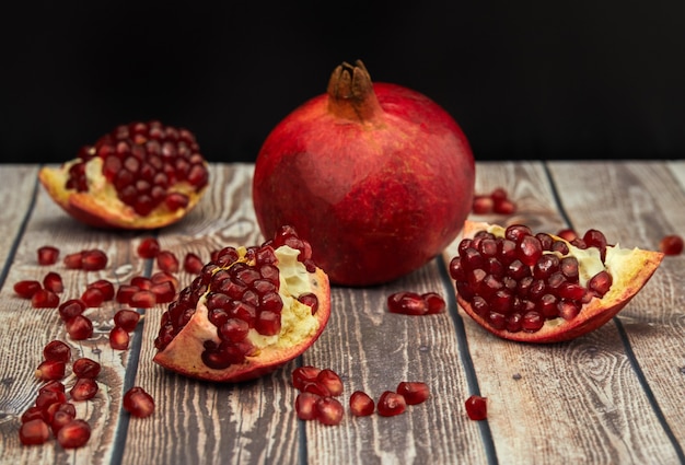 Ripe pomegranate fruit on old brown wooden