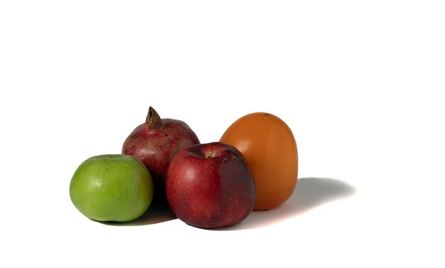 Ripe pomegranate fruit on a white background