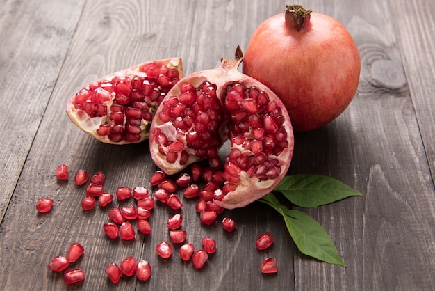 Ripe pomegranate fruit on wooden vintage table