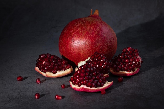 Ripe pomegranate fruits on a dark background.