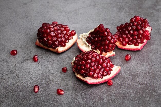 Ripe pomegranate fruits on a dark background.