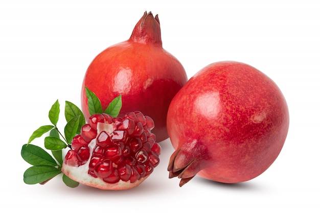 Ripe pomegranate fruits with leaves on the white background. with clipping path.