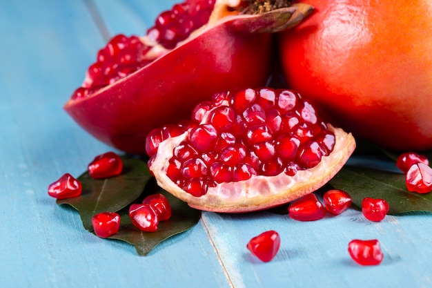 Ripe pomegranate fruits on the wooden background