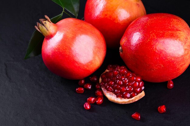 Ripe pomegranate fruits on the wooden background